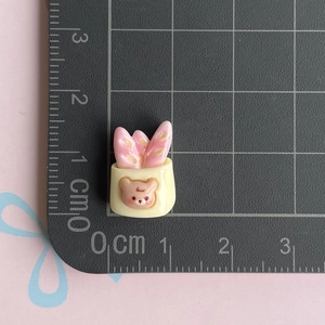 Miniature resin bear and pink rabbit ear charm detail showing 1.5 cm size on ruler
