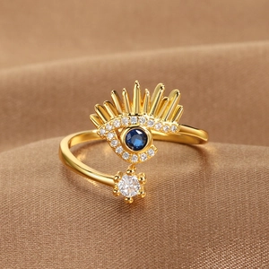 Adjustable 14k gold plated evil eye open ring with blue and white crystals on silk