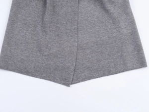 Detailed close-up of the grey knit fabric hem showing fine texture and stitching