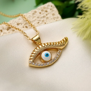 Gold-plated Evil Eye pendant necklace with sparkling zircons on elegant silk fabric