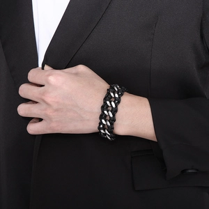 Close-up of men's braided leather bracelet with stainless steel curb chain links