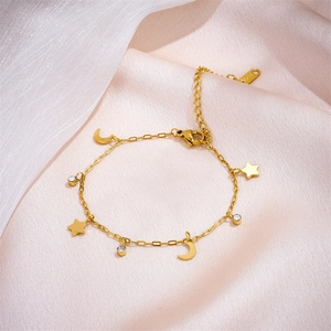Golden stainless steel star and moon charm bracelet with crystals on pink silk fabric