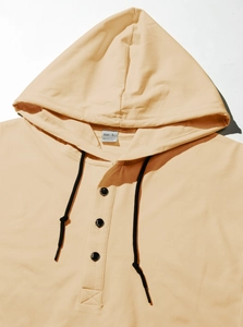 Detail view of khaki hooded sweatshirt showing drawstring, buttons and fabric texture