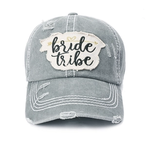 Detail of distressed grey washed canvas baseball cap with white bride tribe letter patch