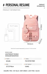 Pink nylon student backpack showing 14-inch laptop storage and heart pendant detail