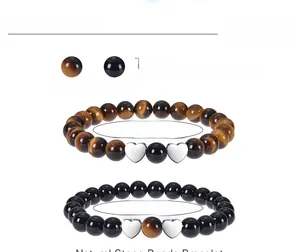 Detail view of 8mm tiger eye and black matte stone beaded bracelets for couples