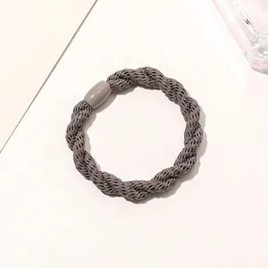 Detailed view of deep grey twisted cord hair tie with a smooth resin cylinder clasp