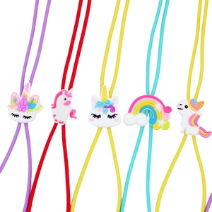 Close-up of colorful elastic eyeglass straps with cute cartoon unicorn and rainbow charms