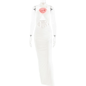 Detail of white halter maxi dress with pink 3D flower and waist cut-out accents