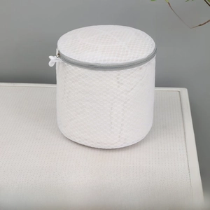 Detail of milky white honeycomb mesh laundry bag with gray zipper for bra protection