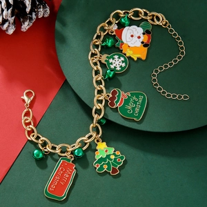Detail of Christmas charm bracelet with Santa, tree, and bells on festive background