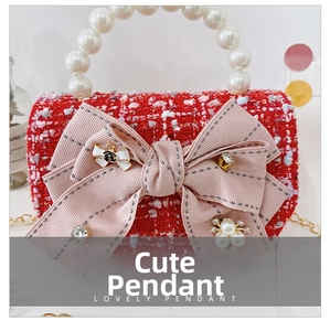 Detail of red tweed girl's bag featuring a large pink bow and pearl carry handle