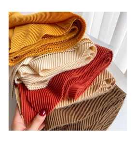 Macro shot of pleated fabric textures in ginger, cream, brick red, and brown colors