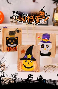 Detail view of burlap Halloween gift bags with felt pumpkin, skull, and black cat embroidery