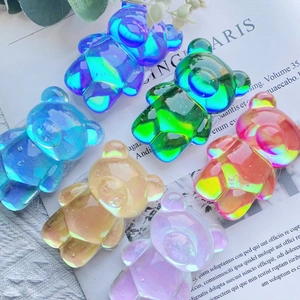 Close-up of iridescent 3D bear-shaped phone grips in multiple translucent jelly colors