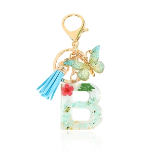 Floral resin letter B keychain with green butterfly charm and blue suede tassel pendant