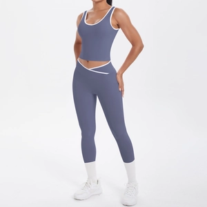 Detail of high-waist yoga pants with V-shaped crossover waist and white contrast binding