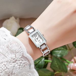 Dettaglio dell'elegante orologio al quarzo rettangolare argento con strass sul polso donna