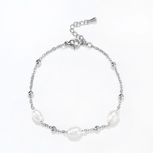 Close-up of delicate pearl chain bracelet with stainless steel beads and lobster clasp
