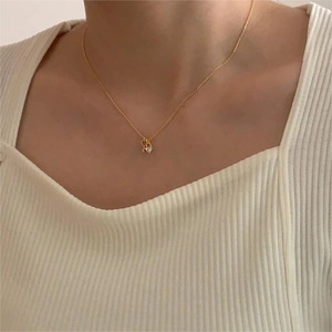 Close-up of a gold heart and key pendant necklace with sparkling cubic zirconia stones