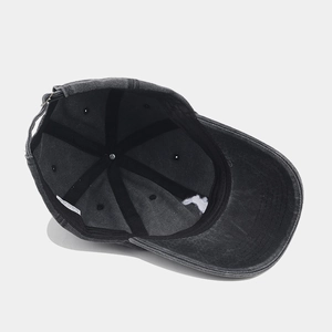 Detail view of washed cotton baseball cap inner lining, stitching, and care label