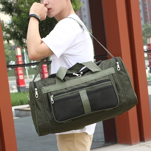 Green large capacity foldable travel duffel bag with shoulder strap shown on a model outdoors