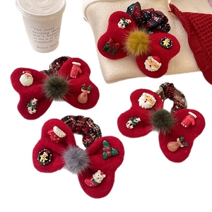 Red Christmas hair scrunchies set with plush balls and festive charms on white background