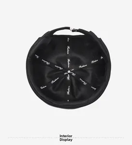 Interior display of black brimless hat featuring fashion ribbon and metal adjustment buckle
