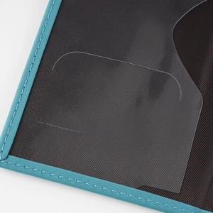 Detail of teal leather trim, black twill lining and clear card slot with reinforced stitching