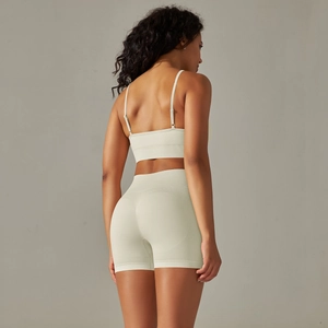Back view of seamless ribbed yoga set featuring thin strap bra and high waist shorts