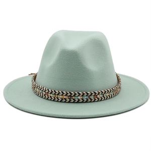 Close-up of mint green wool fedora hat featuring a bohemian herringbone woven band decoration