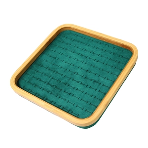 Bamboo jewelry tray with green velvet slots for rings and earrings display
