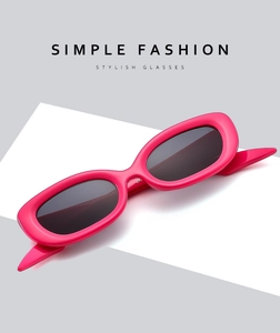 Detailed view of magenta oval frame sunglasses with dark grey lenses in retro style