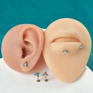 G23 titanium labret studs with opal triangles shown on silicone ear and lip models