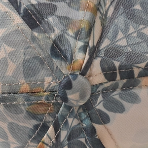 Macro detail of graffiti baseball cap with floral print and reinforced stitching