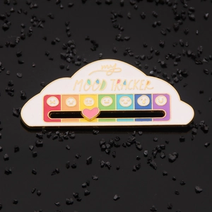 Cloud-shaped mood tracker enamel pin with a sliding pink heart over colorful emojis