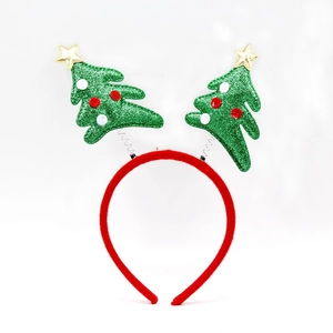 Detail of Christmas headband with green glitter trees on silver springs and red velvet band