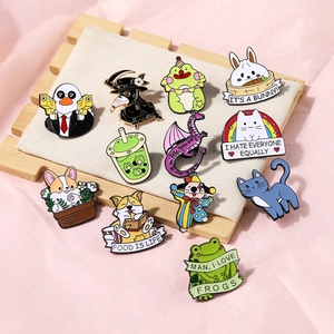 Detailed macro of various cute animal enamel pins including corgi and frog on a wooden tray