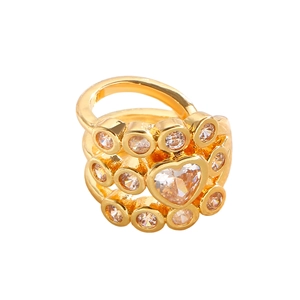 Macro shot of gold-plated ring featuring a large heart-shaped crystal with diamond accents
