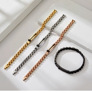 Detail of four metal watch-band style bracelets in gold, silver, rose gold, and black colors