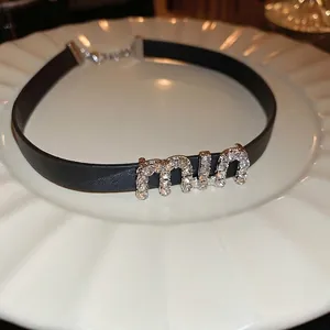 Black leather choker necklace with rhinestone miu lettering and adjustable metal chain