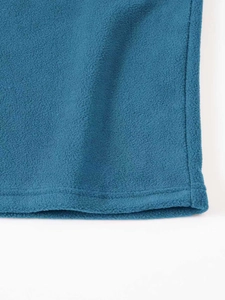 Detailed macro view of the double-needle hem and texture on blue fleece pullover