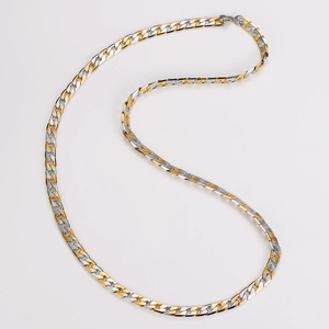 Detailed view of 7mm two-tone gold and silver curb chain necklace with brushed metal texture