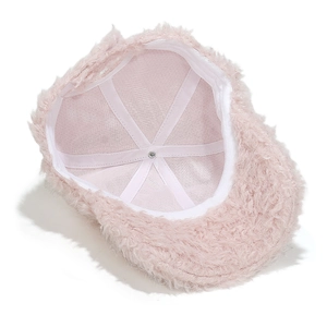 Detail view of pink plush baseball cap interior showing white reinforced stitching and metal stud