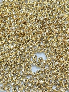 Detailed macro view of 18K gold-plated faceted laser spacer beads for DIY jewelry making