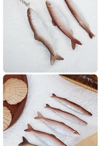 Close-up of realistic dried fish keychain with detailed scales and metal bead chain