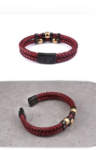 Detail of red and black double-layer braided leather bracelet with magnetic metal clasp