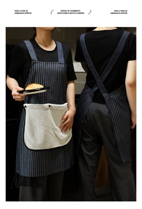 Detail of navy striped apron with H-shaped cross back straps and large towel pocket