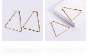 Detailed close-up of 18K gold-plated geometric triangle earrings in high polish