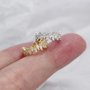 Macro detail of marquise-cut cubic zirconia 925 silver ear cuffs in gold and silver